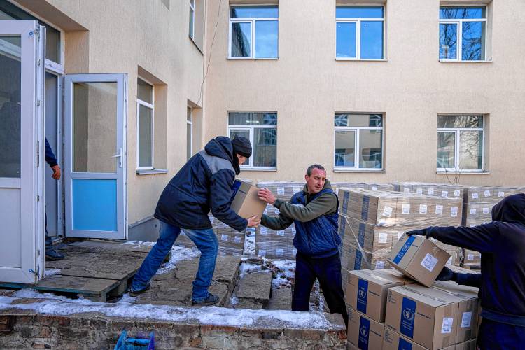 Men unload boxes with humanitarian aid provided by the U.N. World Food Program and ADRA for the residents and internally displaced persons at the distribution center in Kostiantynivka, Ukraine, last February.