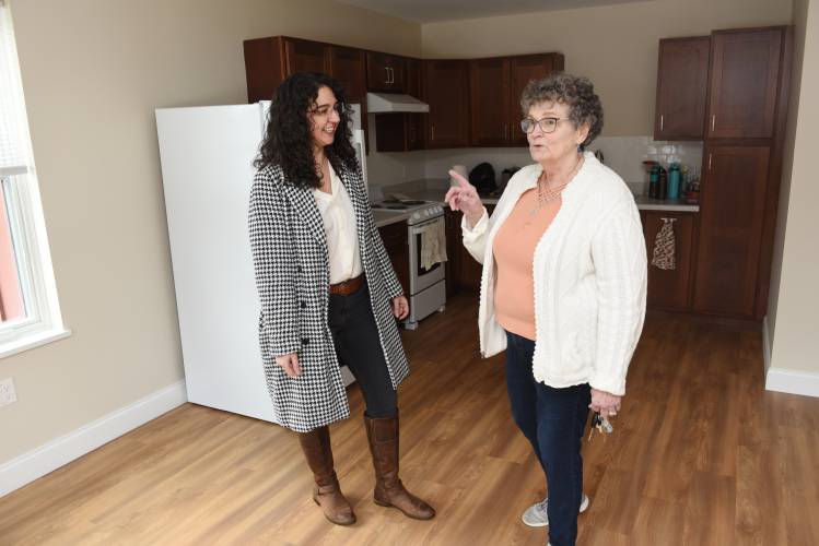 Gina Govoni, executive director of the Franklin County Housing & Redevelopment Authority, talks with tenant Andrea Sullivan in her apartment at Sanderson Place in Sunderland in January. According to Govoni, Sanderson Place is a project that is at the scale Franklin County needs, but contains far fewer units than larger housing developments in urban areas.