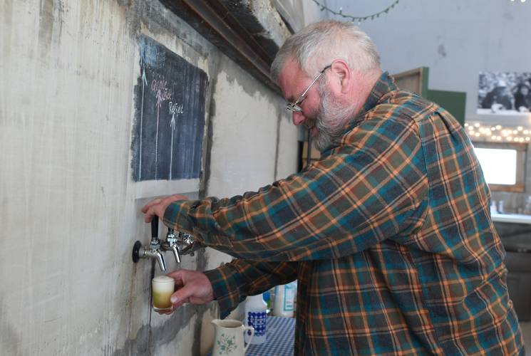 Field Maloney of West County Cider pours a sample of cider in his Peckville Road facility in Shelburne.