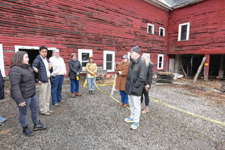 Laura Fisher, executive director of Just Roots farm in Greenfield, left, talks about the state of the barn the farm uses on Friday during a site visit by local, state and federal stakeholders.