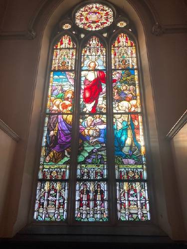 A stained glass window at the shuttered St. Mary of the Assumption Church. The Roman Catholic Diocese of Springfield is suing the city of Northampton seeking the right to remove five stained glass windows from the church, including this one of the ascension of Jesus.