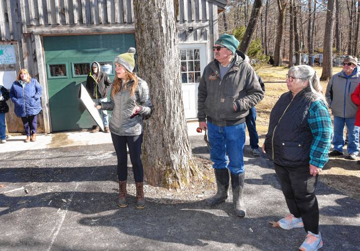 Massachusetts Department of Agricultural Resources Commissioner Ashley Randle reads a proclamation for Massachusetts Maple Month at Severance’s Maple Products in Northfield on Friday morning.  Milt and Robin Severance stand at right.