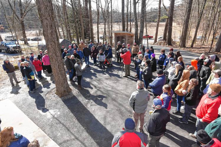 People gather at Severance’s Maple Products in Northfield on Friday morning as Massachusetts Department of Agricultural Resources Commissioner Ashley Randle reads a proclamation for Massachusetts Maple Month.