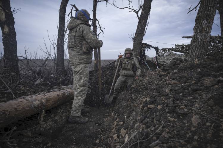 Ukrainian soldiers dig a trench on the front-line near Klishchiivka, Donetsk region, Ukraine, Monday, March 18, 2024.