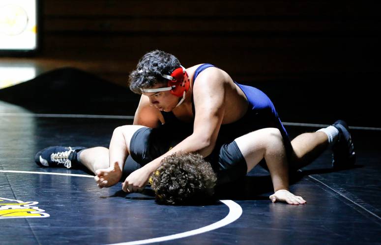 Frontier’s Javion Cabrera, top, competes against Smith Vocational’s Colin Pascal in the 285-pound weight class Wednesday night in Northampton. 