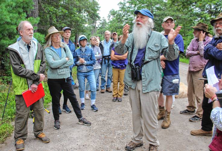 Bill Stubblefield (talking) and Michael Kellett (at left) led a tour of the Montague Plains Wildlife Management Area to share perspectives on current forest management practices.