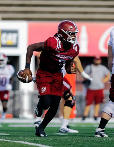 UMass quarterback Taisun Phommachanh (3) looks for an open throw during practice Friday morning at McGuirk Alumni Stadium in Amherst.