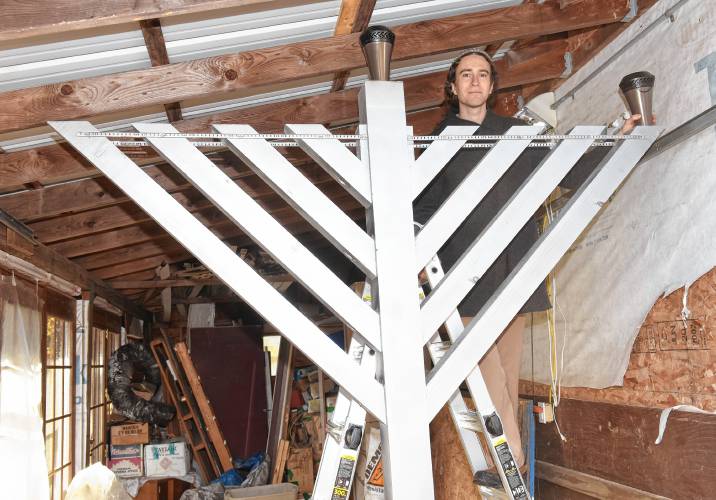 Jasper Lapienski with the Chanukah menorah that will be lit on the Greenfield town common. A dedication ceremony is scheduled for Wednesday, December 13th, at 5:30 p.m.