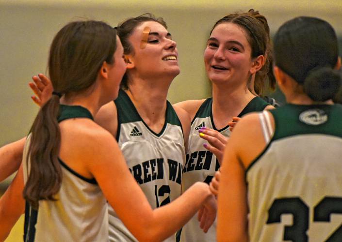 Greenfield’s Amber Bergeron (12) celebrates after sinking a free throw in the fourth quarter for the 1,000th point of her career against Drury on Thursday at Nichols Gymnasium in Greenfield.