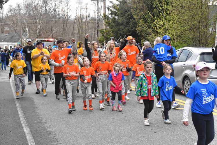 Greenfield Girls Softball League players make their way to Murphy Park during its Opening Day parade on Saturday. 