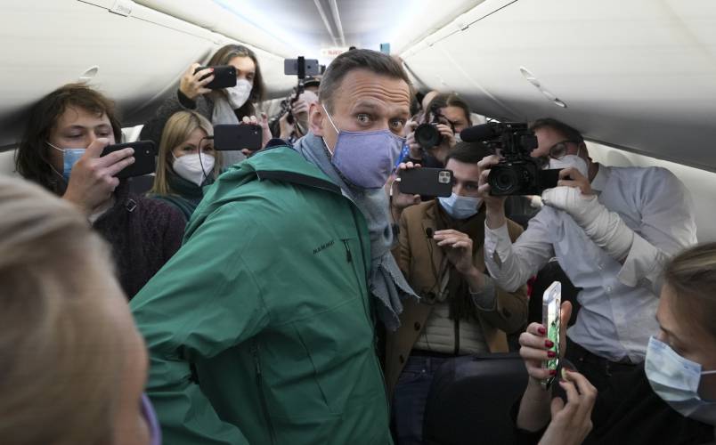 Alexei Navalny is surrounded by journalists inside a plane carrying him back to Russia from the airport near Berlin, Germany, on Sunday, Jan. 17, 2021. Navalny, who was President Vladimir Putin’s fiercest political foe, died in a Russian prison on Feb. 16, 2024.