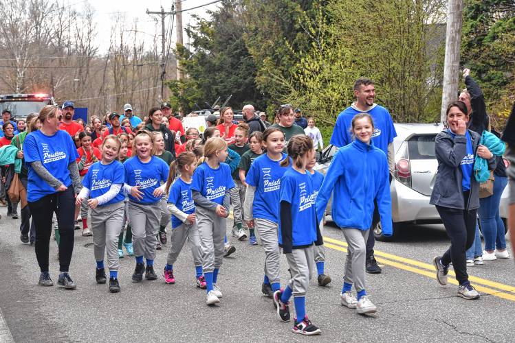 Greenfield Girls Softball League players make their way to Murphy Park during its Opening Day parade on Saturday.