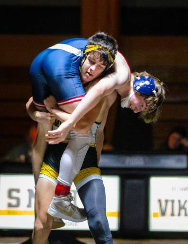 Smith Vocational’s Mateo Henriques lifts Frontier’s Wyatt Finch while competing in the 120-pound weight class Wednesday night in Northampton. 
