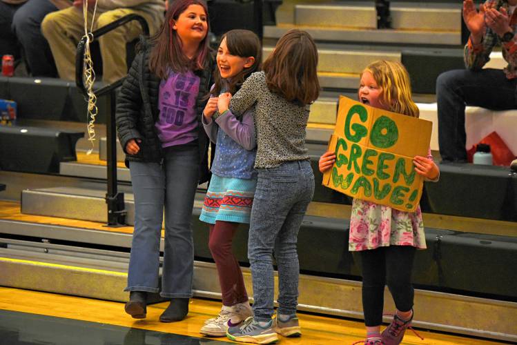 Young Greenfield fans celebrate after Greenfield’s Amber Bergeron (12) became the eighth player in school history to score 1,000 points during action against Drury at Nichols Gymnasium in Greenfield on Thursday.