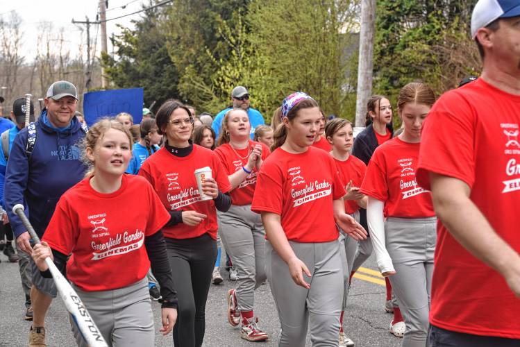 Greenfield Girls Softball League players make their way to Murphy Park during its Opening Day parade on Saturday.