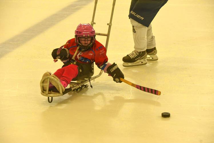 Sled hockey participant Harper makes a play on the puck during CHD's All In Sled Hockey Open Skate on Monday at the Mullins Center practice rink in Amherst.