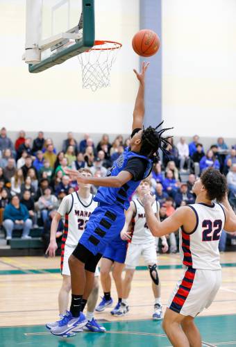 Granby’s Gavier Fernandez (5) drives in for a layup against Mahar in the third quarter of the Western Mass. Class C boys basketball championship Saturday at Holyoke Community College.