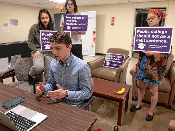 Mark Murdy, a University of Massachusetts Amherst graduate student, speaks at the board of trustees’ virtual meeting Wednesday morning to oppose tuition and fee hikes going into effect this fall. UMass students Ella Prabhakar, Riley Campbell and Yongqi Gingrass stand behind him.
