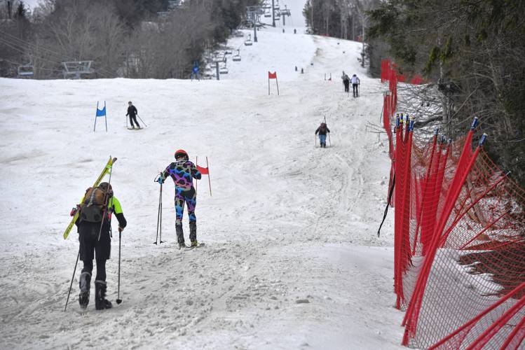 Competitors in the Berkshire Highlands Pentathlon make the climb up the mountain for the ski portion of the race on Saturday at Berkshire East. 