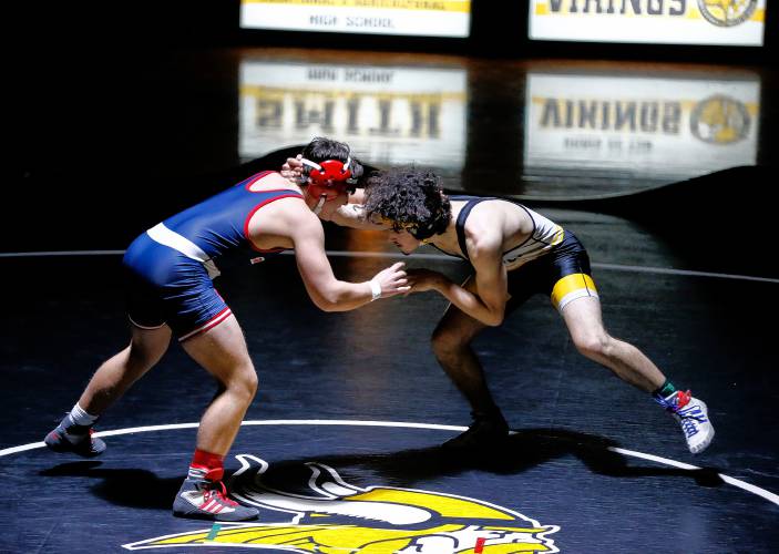 Frontier’s Konner James competes against Smith Vocational’s Aaron Fein in the 150-pound weight class Wednesday night in Northampton. 