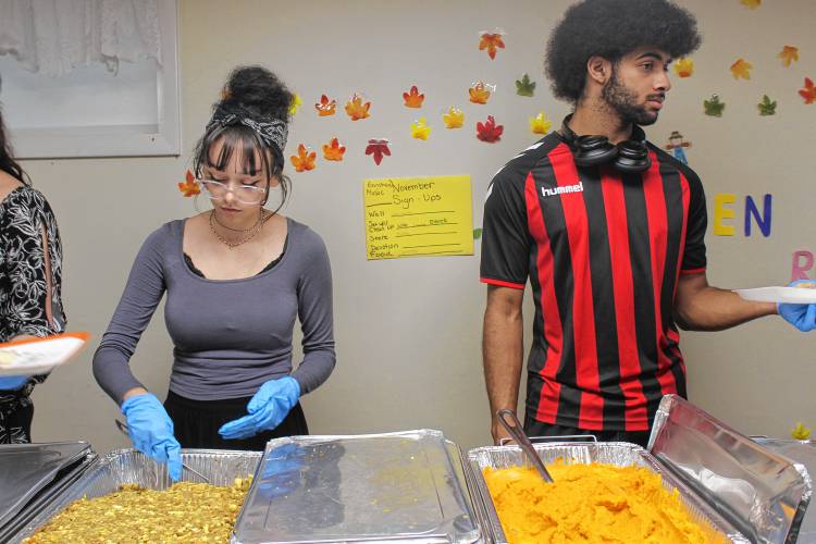 From left, Leira Lebron and London Washington serve food at Living Waters Assembly of God in Greenfield.