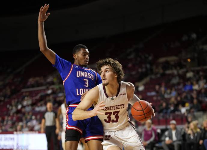 UMass forward Matt Cross (33) dribbles to the basket past UMass Lowell’s Quinton Mincey (3) during the Minutemen’s 91-77 victory on Saturday at the Mullins Center in Amherst.