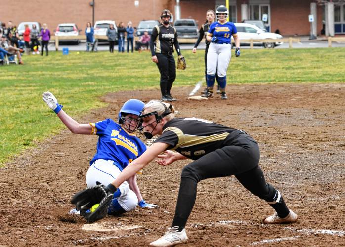 Mohawk Trail’s Bella Brown slides home safely to score a run as Pioneer’s Kelly Baird is late with the tag during the visiting Warriors’ 19-4 victory in Northfield on Thursday.