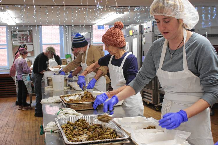 Volunteers serve food at Stone Soup Café in Greenfield.