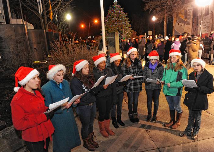 Singers don festive Santa hats at Veterans Mall in Greenfield following the annual tree lighting. This year’s tree lighting is set for Friday at 5 p.m.