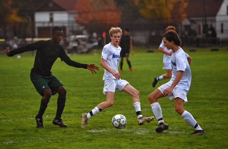 Greenfield’s Clivens Carter Michel (5), left, tries to intercept a pass against Monson during the host Green Wave’s 3-0 loss at Vets Field on Wednesday.