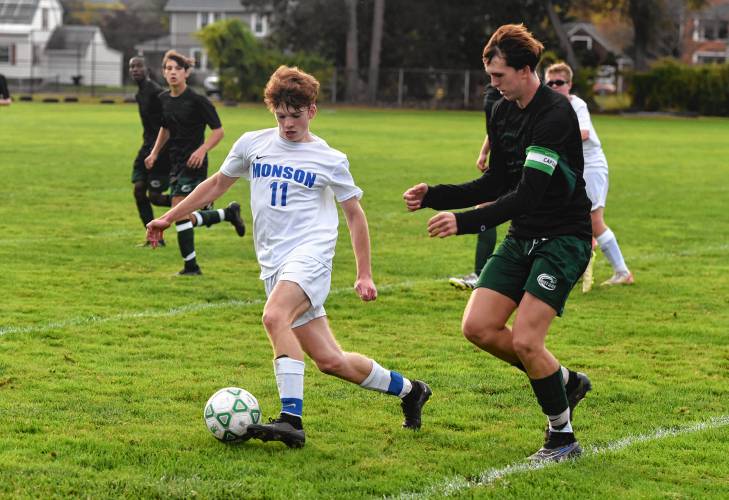 Monson’s Colin Beaupre (11), left, is defended by Greenfield’s Jacob Blanchard (10) during the host Green Wave’s 3-0 loss at Vets Field on Wednesday.