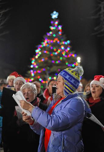 The Franklin County Community Chorus was joined by the Stoneleigh-Burnham School Octet singing holiday songs at the tree lighting at Veterans Mall in Greenfield in 2016. This year’s tree lighting is set for Friday at 5 p.m.