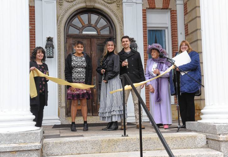 A ribbon-cutting ceremony was held on Monday for the Revival Wheeler Mansion in Orange that owner Cynthia Butler has been restoring. From left are Missy Eaton of the North Quabbin Chamber of Commerce, Butler’s daughter Makayla Butler, Butler with scissors, her son Zachary Preston, Rose Marie Thoms of Rose Cottage Bed & Breakfast and state Rep. Susannah Whipps, I-Athol.