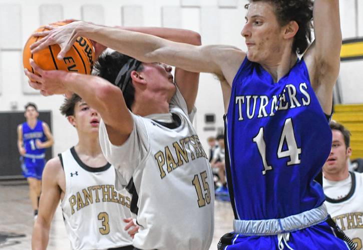 Pioneer’s Alex McClelland has his shot altered by Turners Falls’ Branden Truesdell during the Panthers’ 74-26 victory on Tuesday night at Messer Gymnasium in Northfield.