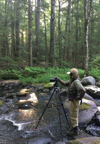 Photographer Roberto Mighty takes photos of the East Branch of the Swift River. These 16 photos would later be merged to create the Fisher Museum’s panorama.