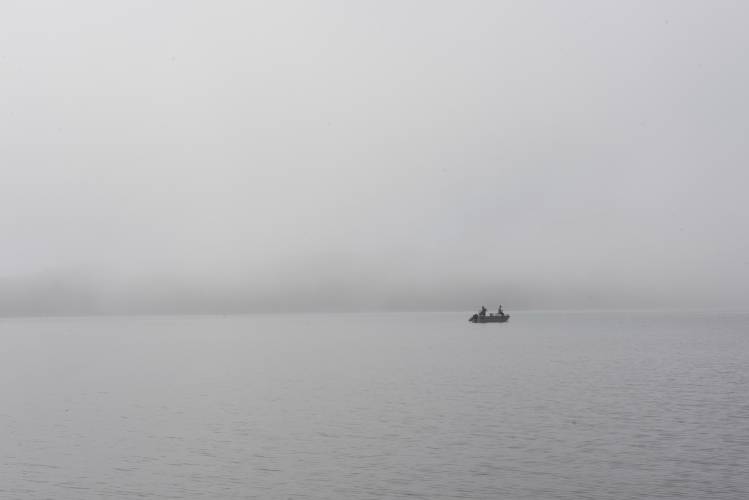 A fishing boat emerges from the morning fog on the Quabbin Reservoir near New Salem in 2021. The reservoir will open for fishing on Saturday, April 20.