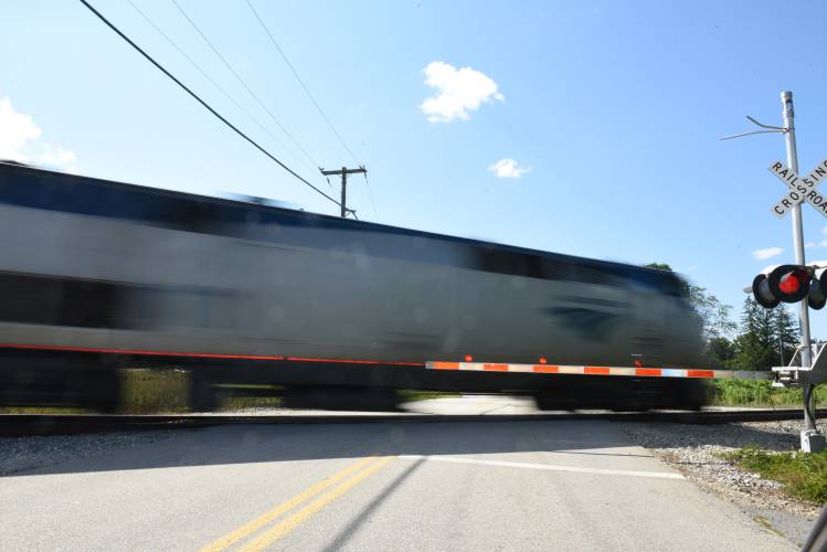 A northbound Amtrak train crosses North Hillside Road in Deerfield in July 2022.