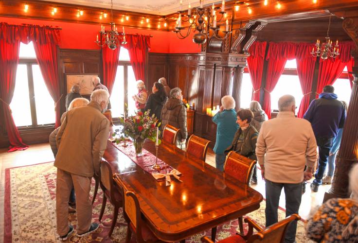 People tour the Revival Wheeler Mansion in Orange on Monday after a ribbon-cutting ceremony celebrating its opening as a bed and breakfast.