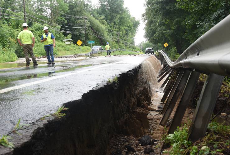 Water flows over Greenfield Road in Deerfield (Routes 5 and 10) after heavy rain washed out the guardrail near Keets Road in July.