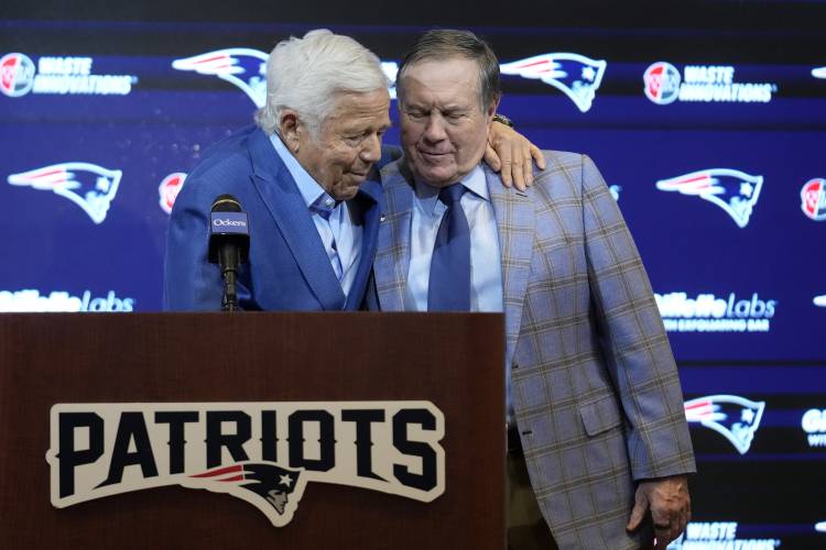 New England owner Robert Kraft, left, and former coach Bill Belichick embrace during a news conference Thursday.