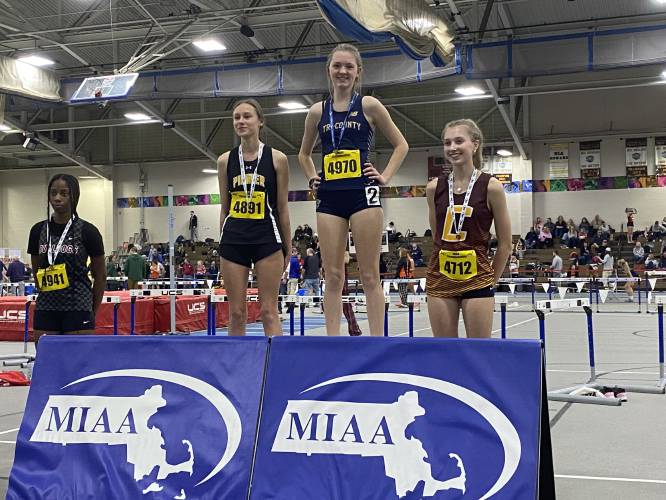 Pioneer's Louise Flagollet (4891) receives her medal after placing second in the high jump at the MIAA Division 5 Indoor Track and Field Championship at the Reggie Lewis Center in Boston on Wednesday.