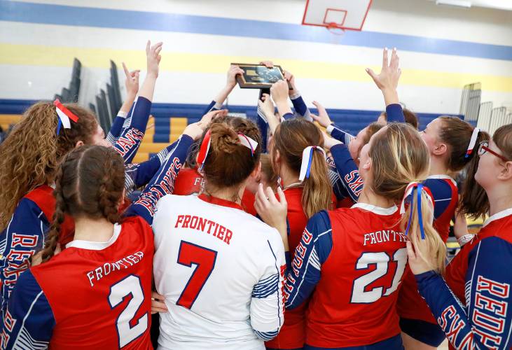 Frontier players celebrate after receiving the Western Massachusetts Class B girls volleyball championship trophy after defeating Baystate Academy on Saturday at Chicopee Comp.