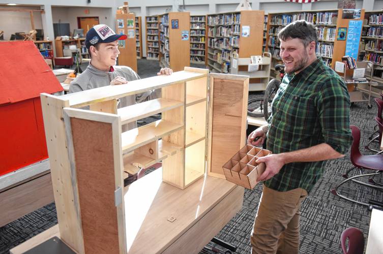Ralph C. Mahar Regional School student Carmichael Thompson shows his tool storage creation for his garage to Chris Stark, Mahar Makerspace teacher, at the Mahar Makers’ Makerfaire on Wednesday.