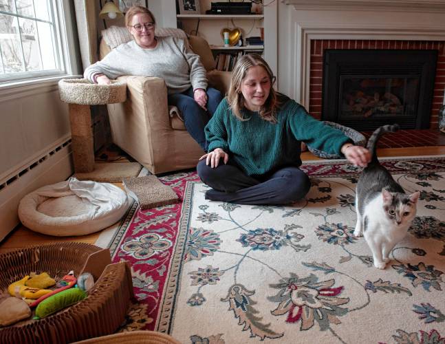 Beth Malloy and Hannah Solar with Jasmine, their cat, at their home in South Deerfield.