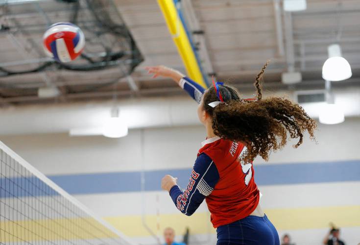 Frontier’s Gabrielle Adams (5) hits at the net against Baystate Academy in the first set of the Western Mass. Class B girls volleyball final Saturday at Chicopee Comp.