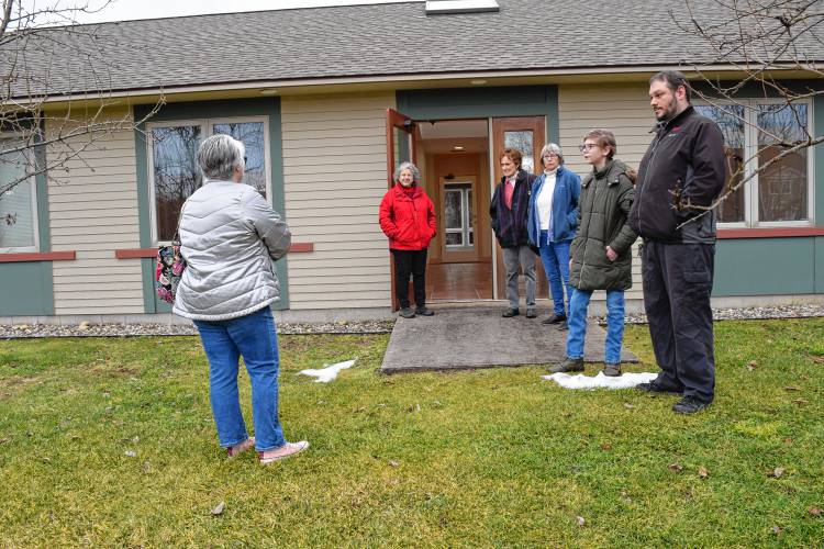  Jennifer Remillard, the director of the South County Senior Center, gives a tour of the exterior of a potential new senior center at 23 Plumtree Road.