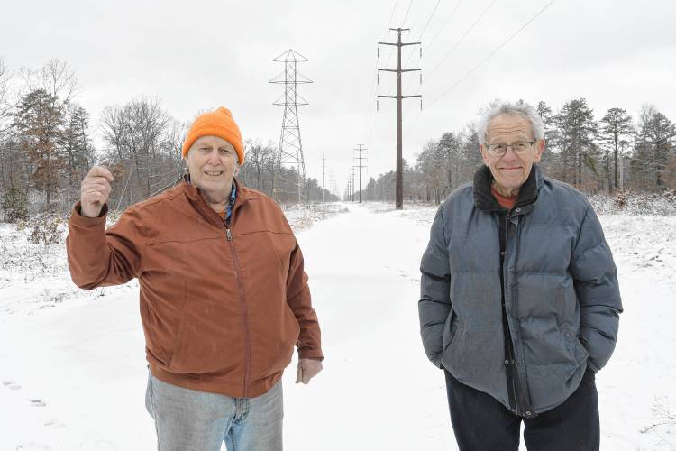 Sam Lovejoy and Dan Keller stand at the Montague Plains where, 50 years ago, Lovejoy toppled a weather tower being used to collect data for a proposed nuclear power plant. Keller drove Lovejoy to the area of the site in the middle of the night on Feb. 22, 1974, and chronicled the event and ensuing court case in the one-hour documentary film “Lovejoy’s Nuclear War” the following year. The film will be shown at the Shea Theater Arts Center on the 50th anniversary of the event.