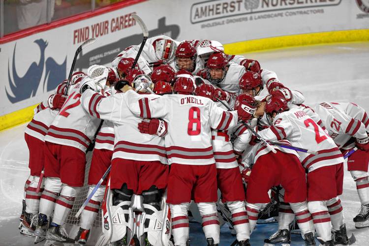 UMass players huddle up prior to their season opener against AIC at the Mullins Center in Amherst.