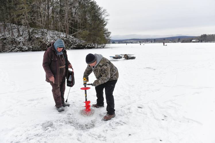 Greenfield resident Fiodor Tahig and Westfield resident Peter Mokan drill holes and use a fish finder to look for fish on Barton Cove in Gill on Friday.