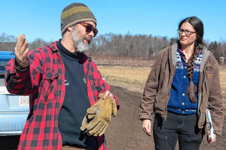 Ryan and Sarah Voiland, owners of Red Fire Farm in Granby, talks with Representative Dan Carey on Tuesday, Feb. 20, 2024, about the damage from the fire Saturday afternoon and what it will take to rebuild.
